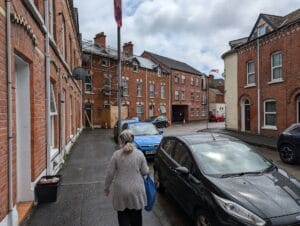 A short street where every residential building abuts to the next, all in red brick, 2- and 3-storeys tall. In the U.K. they're called "Mews" -- converted stables, or flats that are generally meant to look like that. In the U.S. we'd call them townhouses.